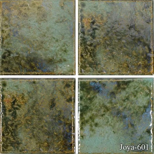Four square mottled green-blue ceramic tiles with dark marbling and white grout lines