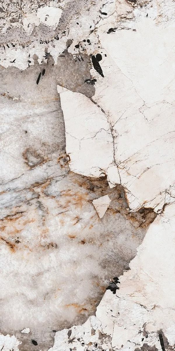 White marble-like stone surface with gray veining and brown cracks, close-up texture