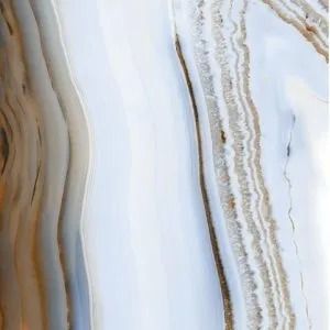 White and beige marble-like stone with wavy tan and brown veining
