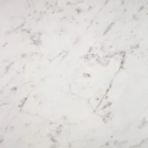 White marble surface with faint gray veining and subtle stains