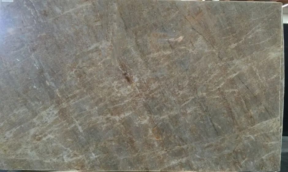 Close-up of a gray-brown stone or tile surface with subtle veining and scratches.