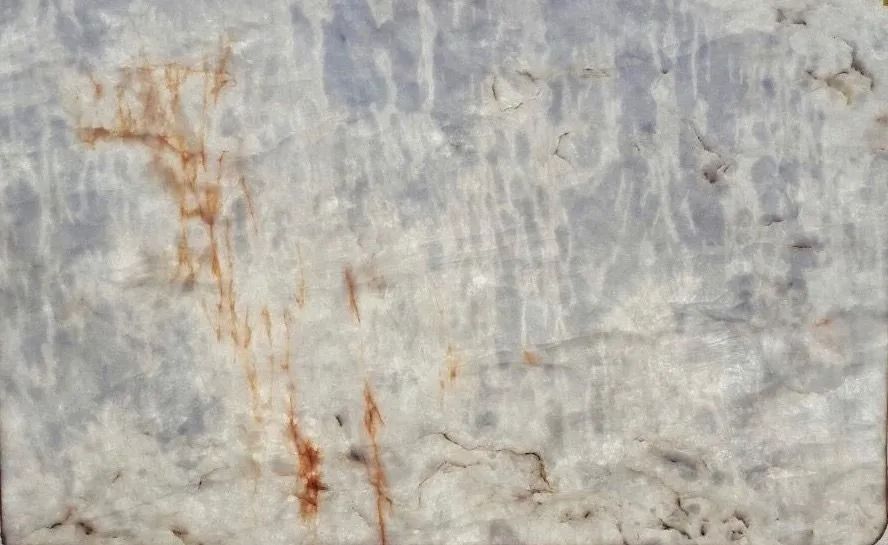 Weathered gray concrete wall with rusty orange stains and streaks