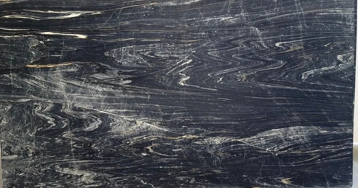 Dark, scratched slate-gray textured surface with white streaks and marks