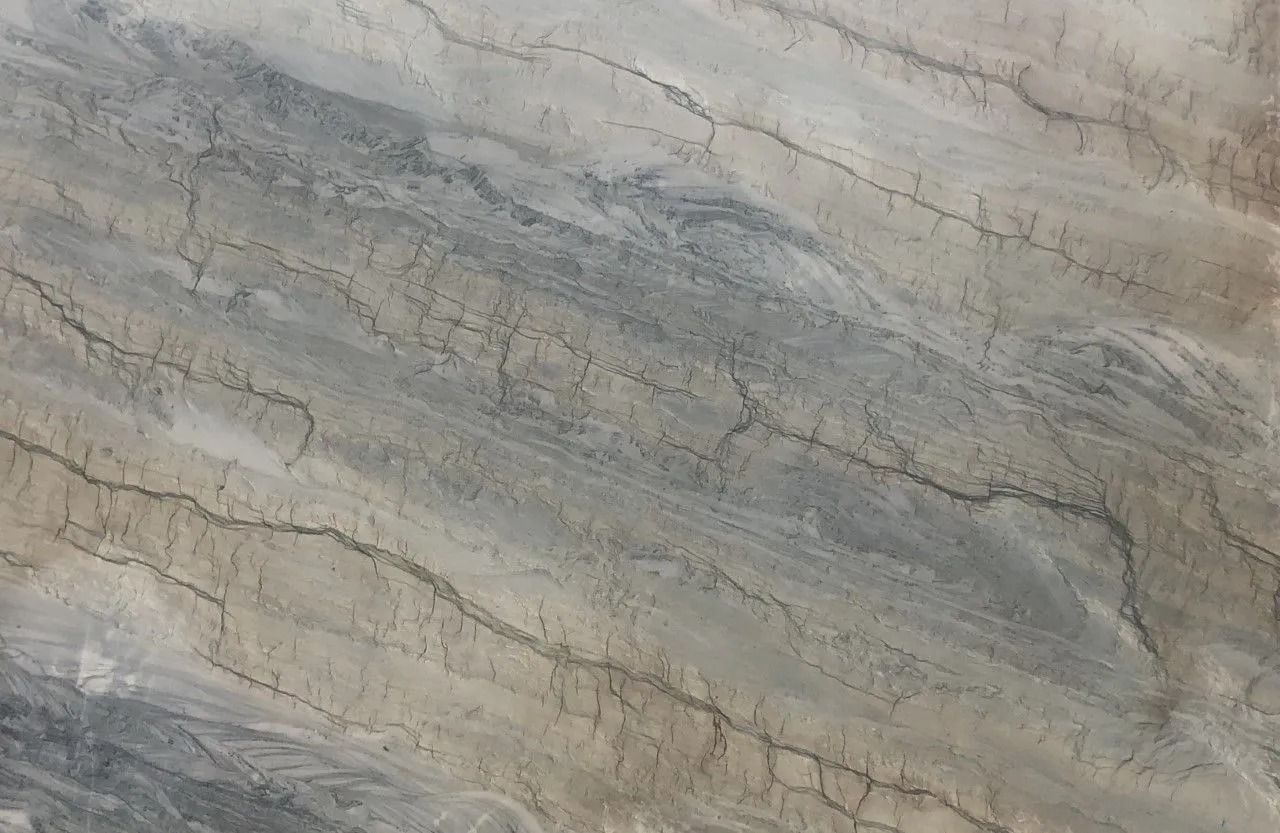 Close-up of gray and beige veined stone or marble texture