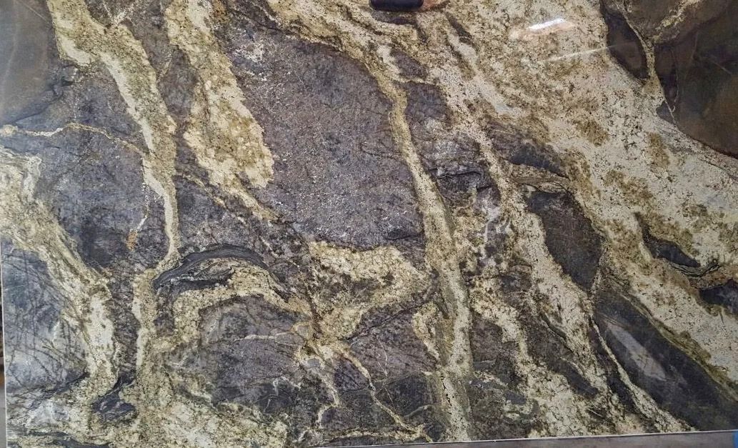 Close-up of a gray and tan marbled rock surface with wavy mineral veins