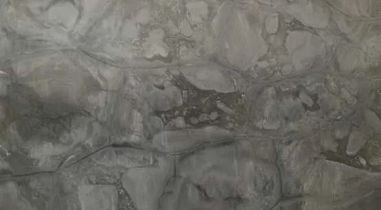 Gray marbled stone surface with cloudy veining and rough texture
