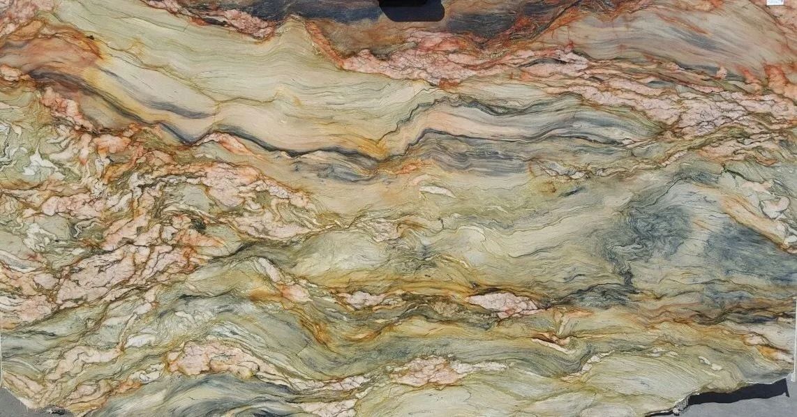Mottled beige, gray, and rusty-brown stone with wavy layered mineral bands.