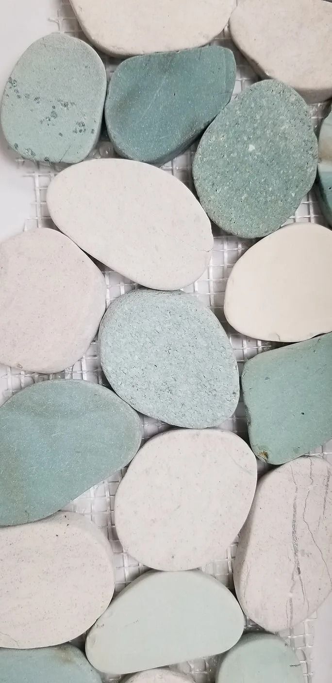 Close-up of pastel blue and white pebbles arranged in a mosaic pattern