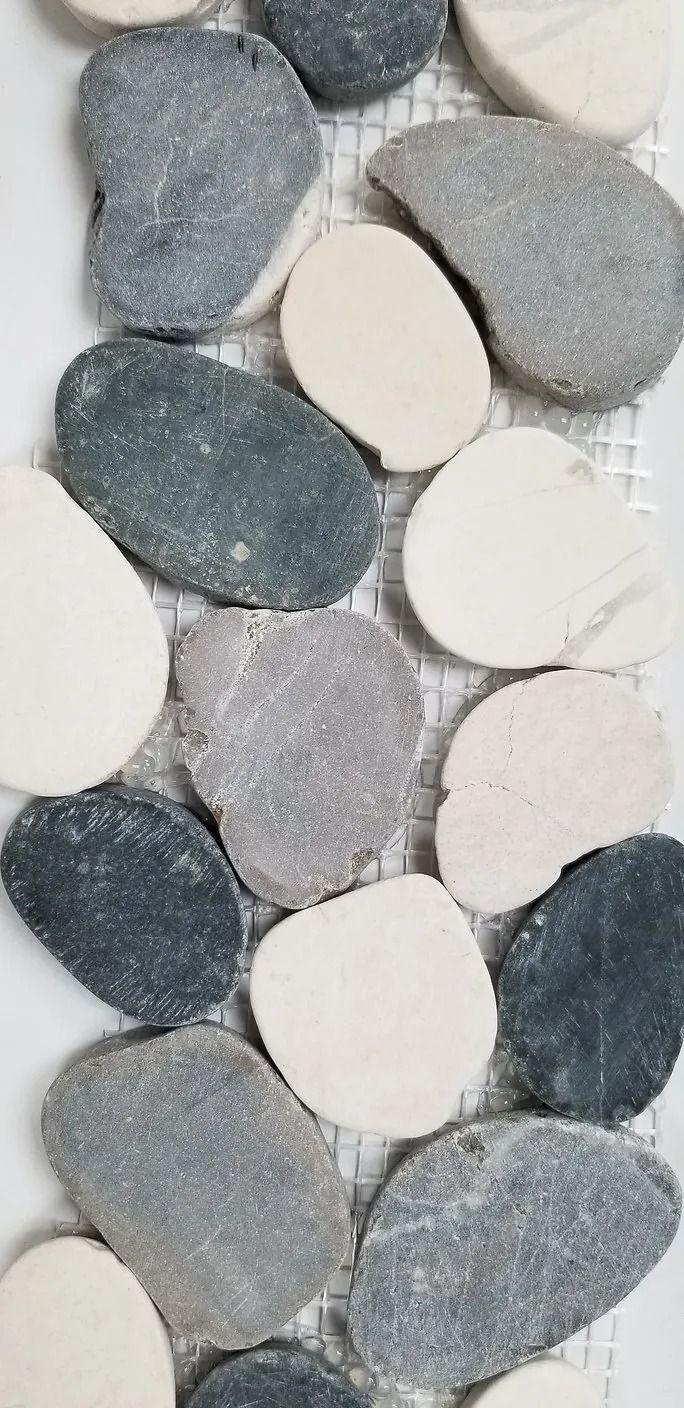 Pebble-like textured stones in gray, white, and dark blue arranged in a vertical pattern