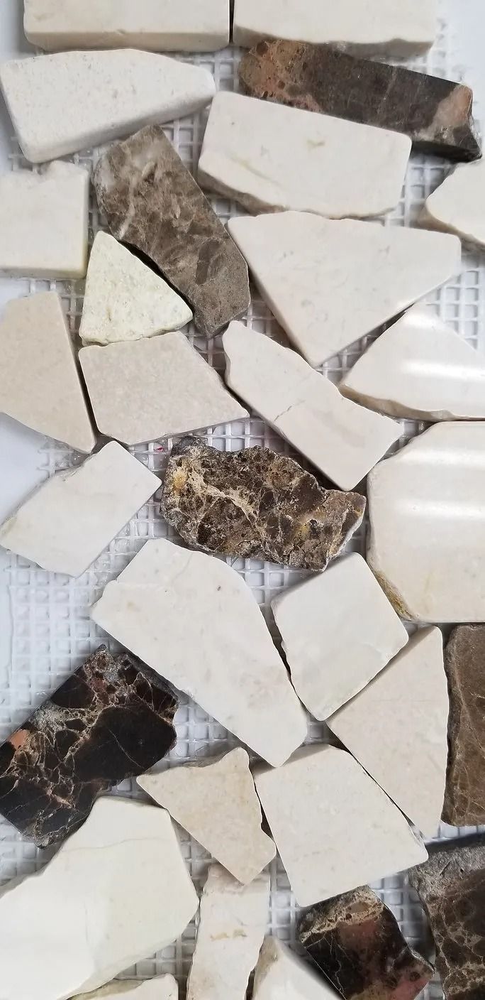 Broken white ceramic tiles scattered on a floor with gaps showing debris underneath