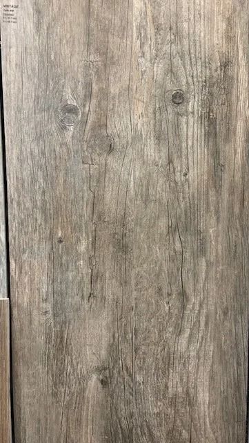 Close-up of weathered gray-brown wood planks with visible grain and knots
