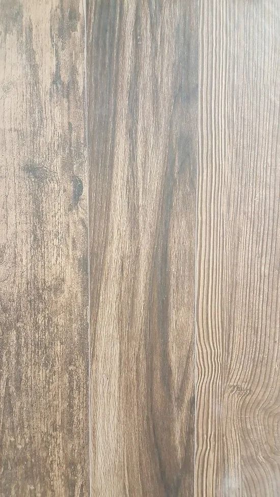 Close-up of light brown wood grain with vertical planks and gray weathered streaks