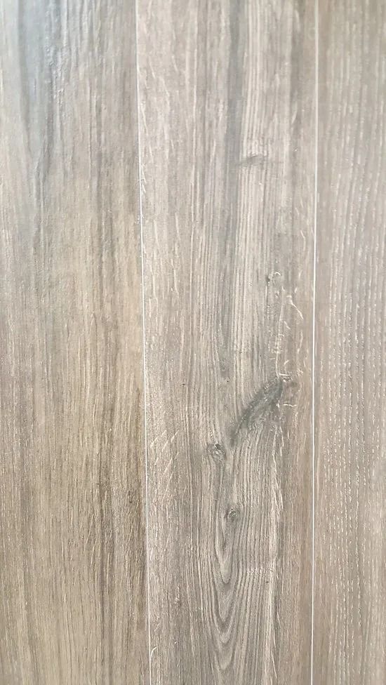 Close-up of light gray wood grain with a small dark knot