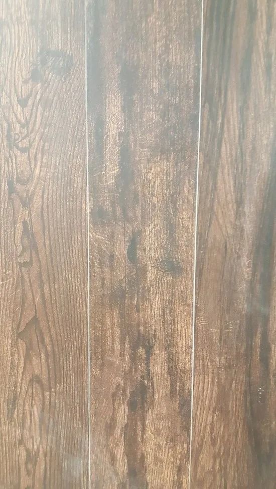 Vertical dark brown wood grain planks with a weathered, rustic finish