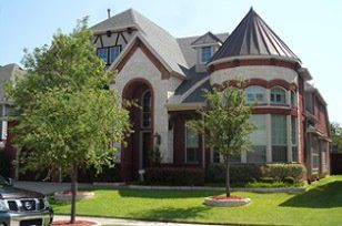 A large house with a car parked in front of it