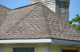 A close up of a roof of a house with a chimney.