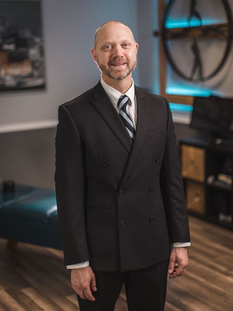 A picture of Dr. Joseph Anderson, D.C. in a black suit, vice president of Kansas City Laser-Like Lipo