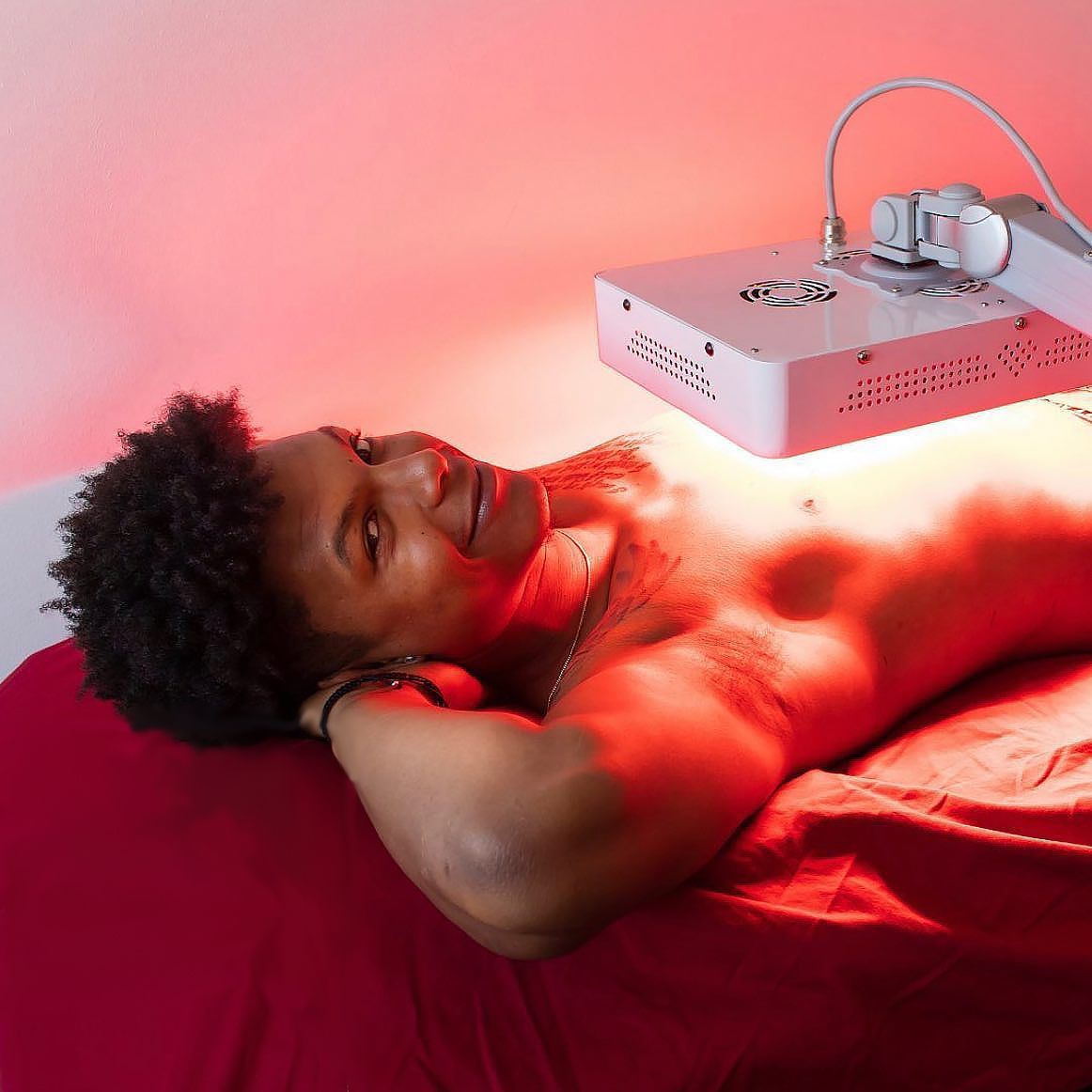 A black man receiving an UltraSlim treatment on his stomach