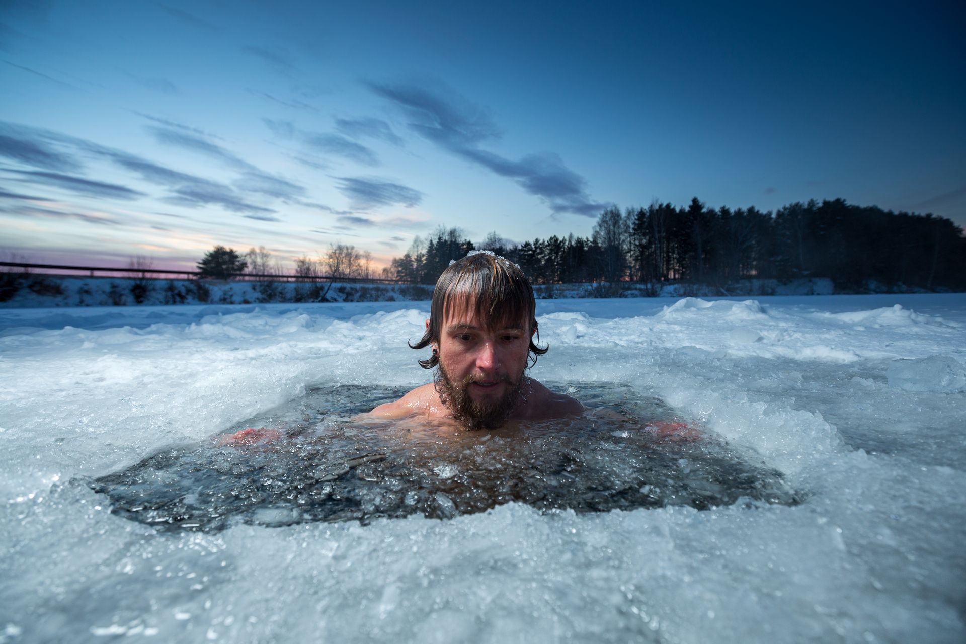 A white man taking an ice bath