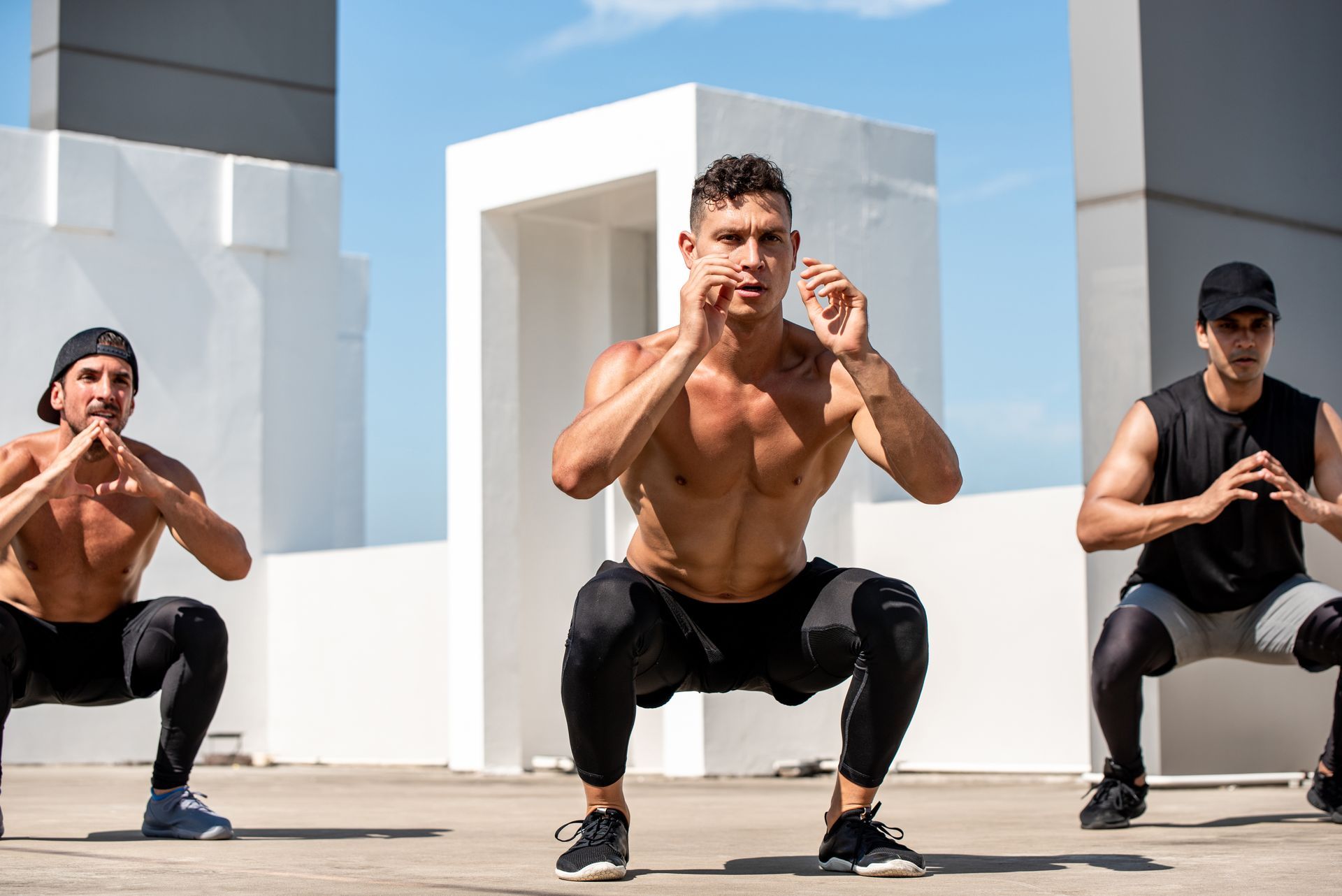 Three white men working out doing high intensity interval training