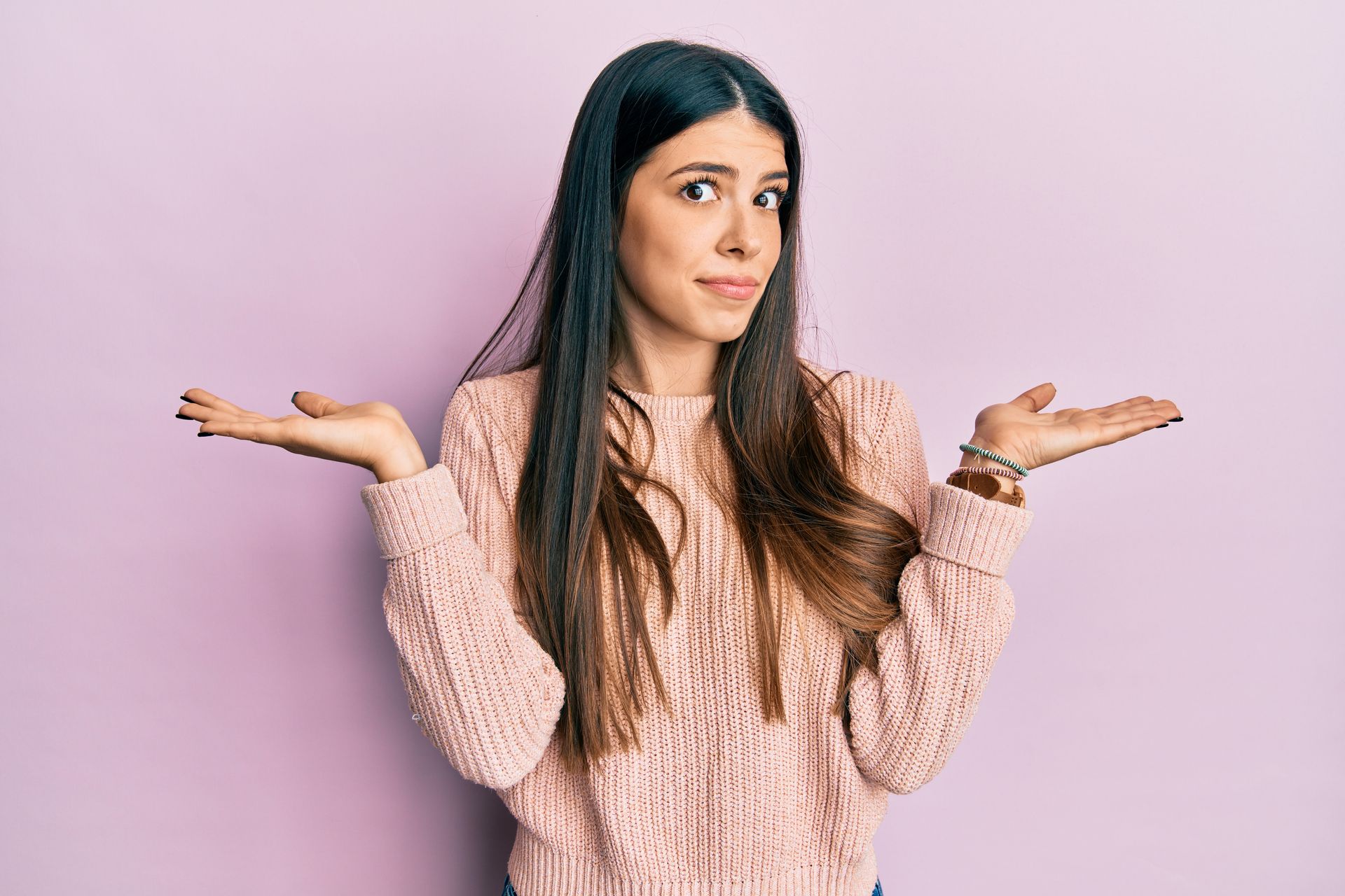 A young white woman with her hands in the air making excuses