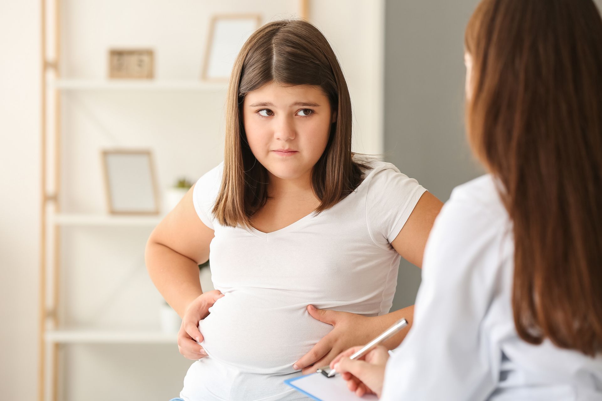 An overweight elementary aged girl at the doctor's office