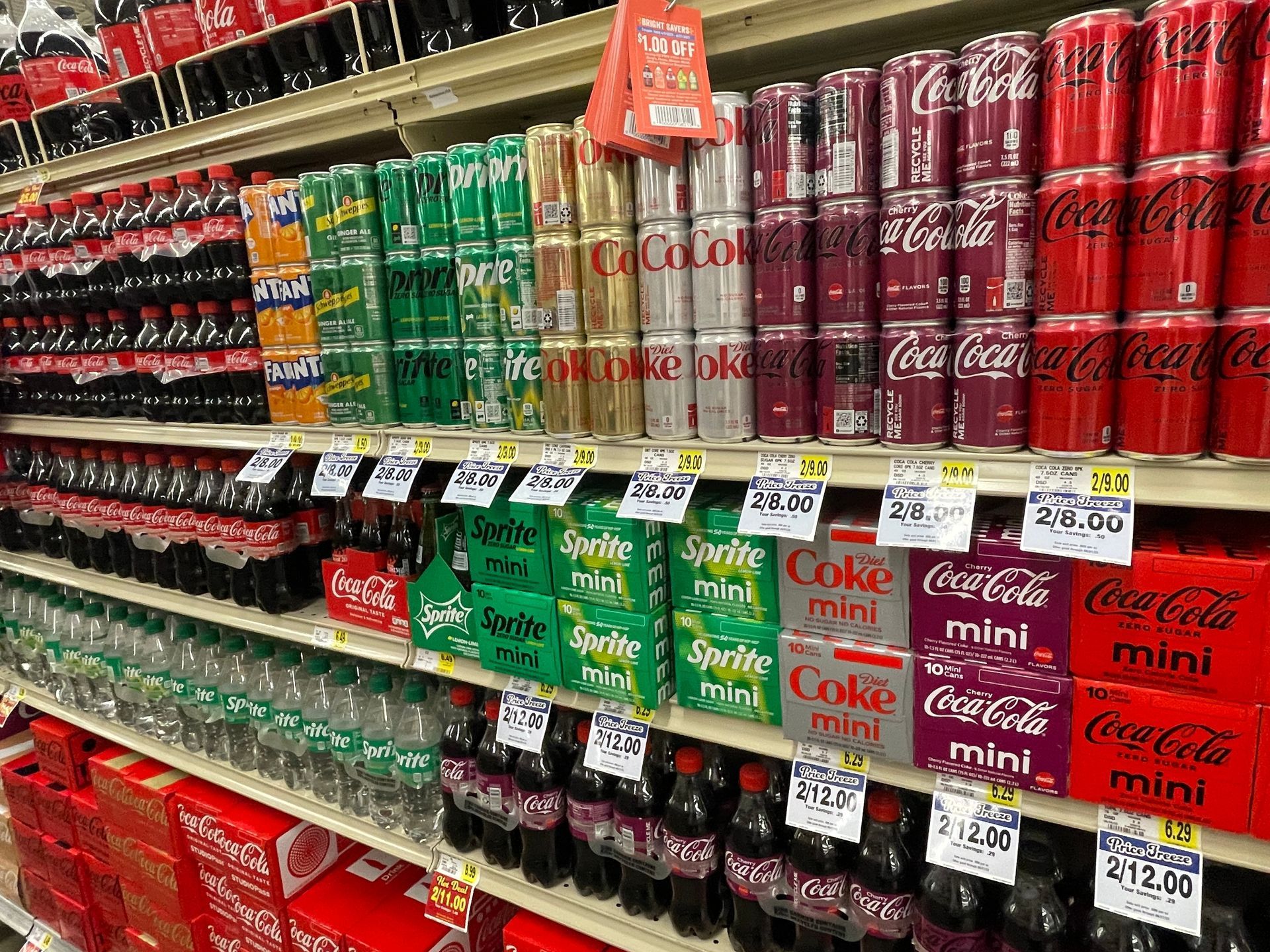 Tons of different soda on a soda isle at a grocery store