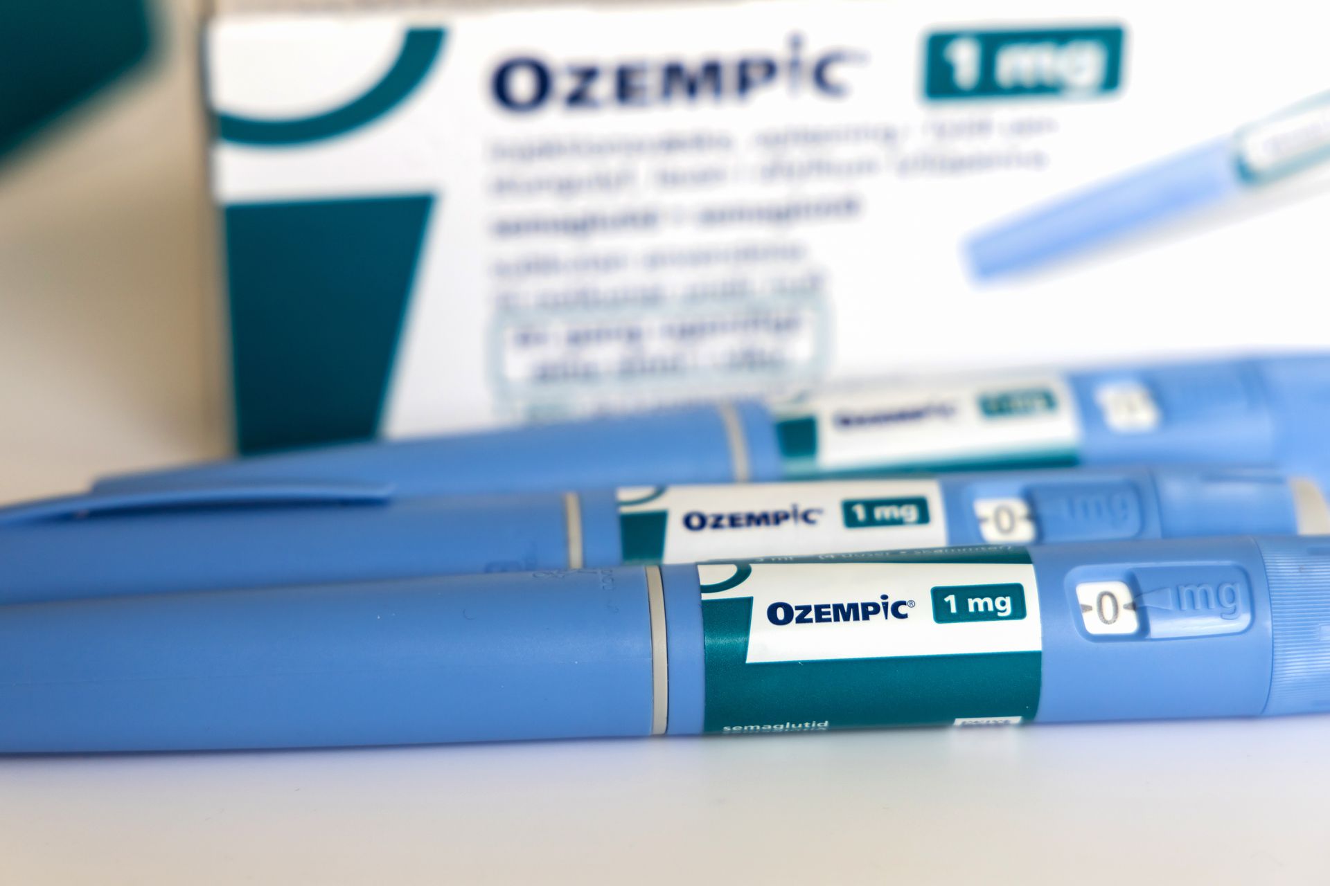 Two Ozempic injection pens sitting in front of an Ozempic box