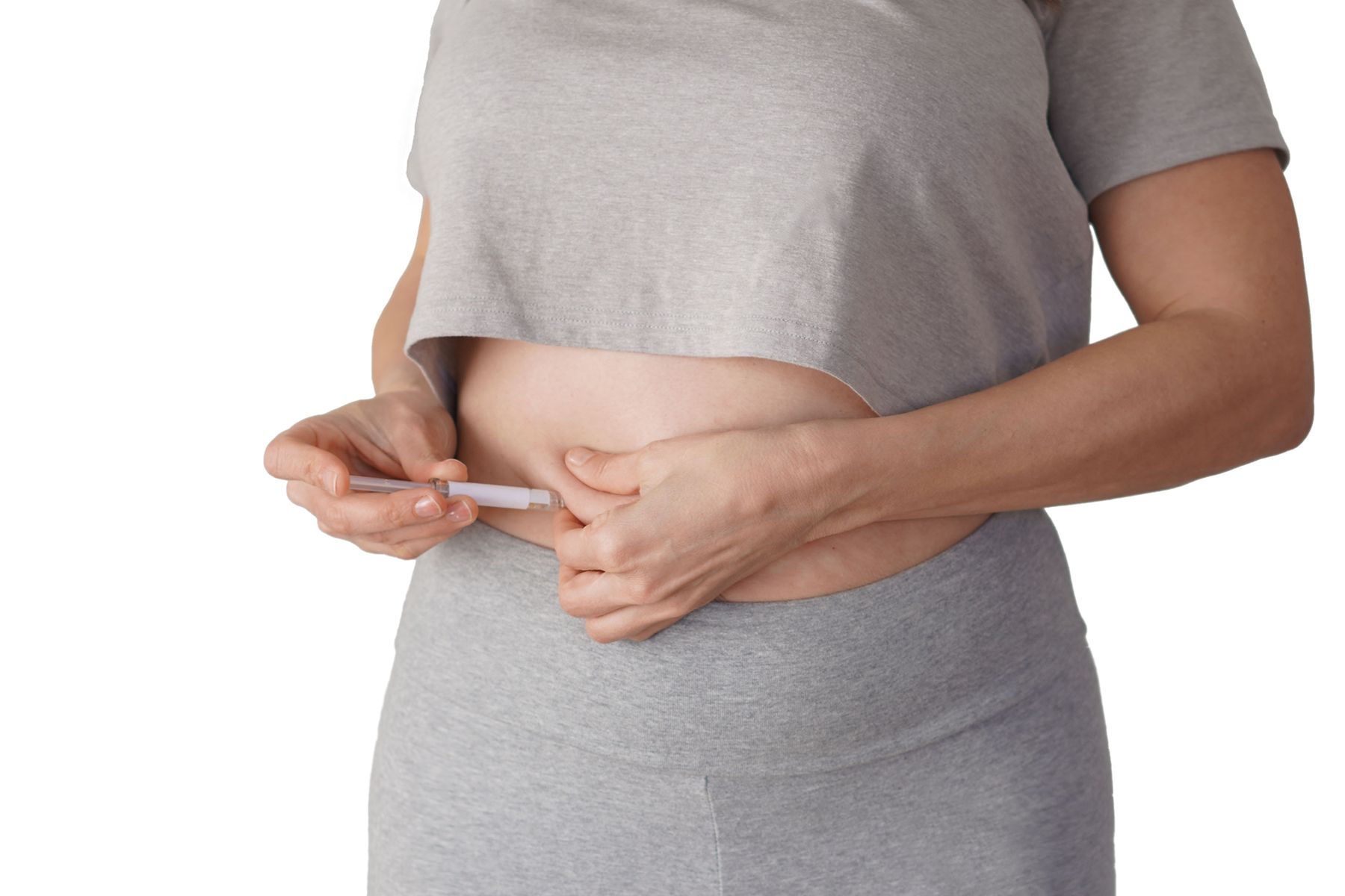 A woman giving herself a GLP-1 injection