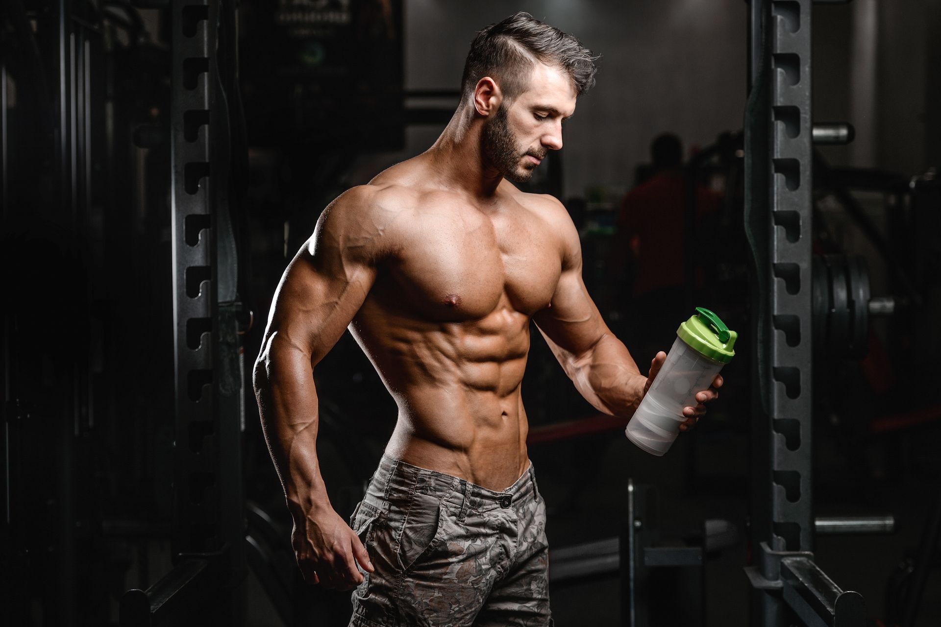 A ripped white man holding a protein shake