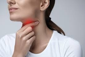 Woman touching her neck, a red glow highlighting the throat, suggesting pain or discomfort.