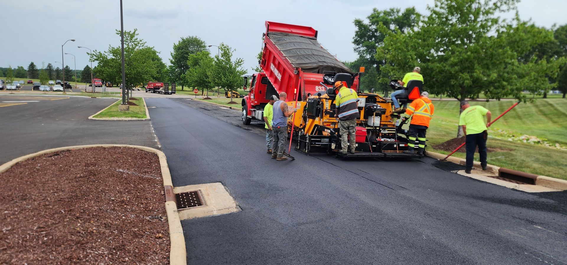 A group of construction workers are working on a road.