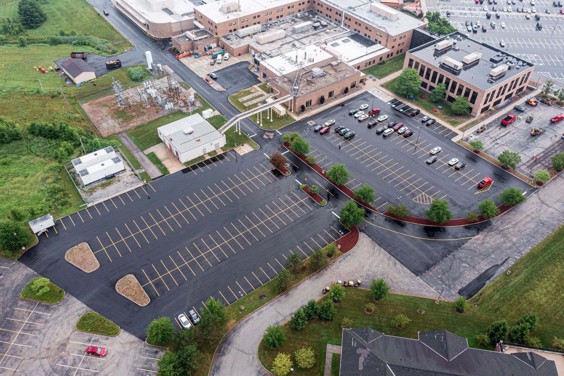 An aerial view of a parking lot in front of a large building.