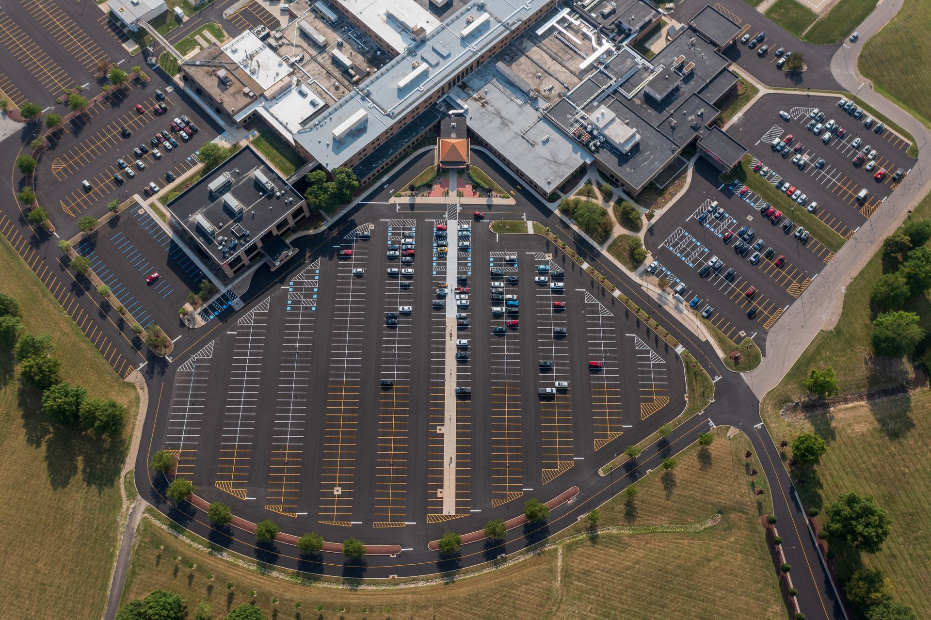 An aerial view of a parking lot in front of a large building