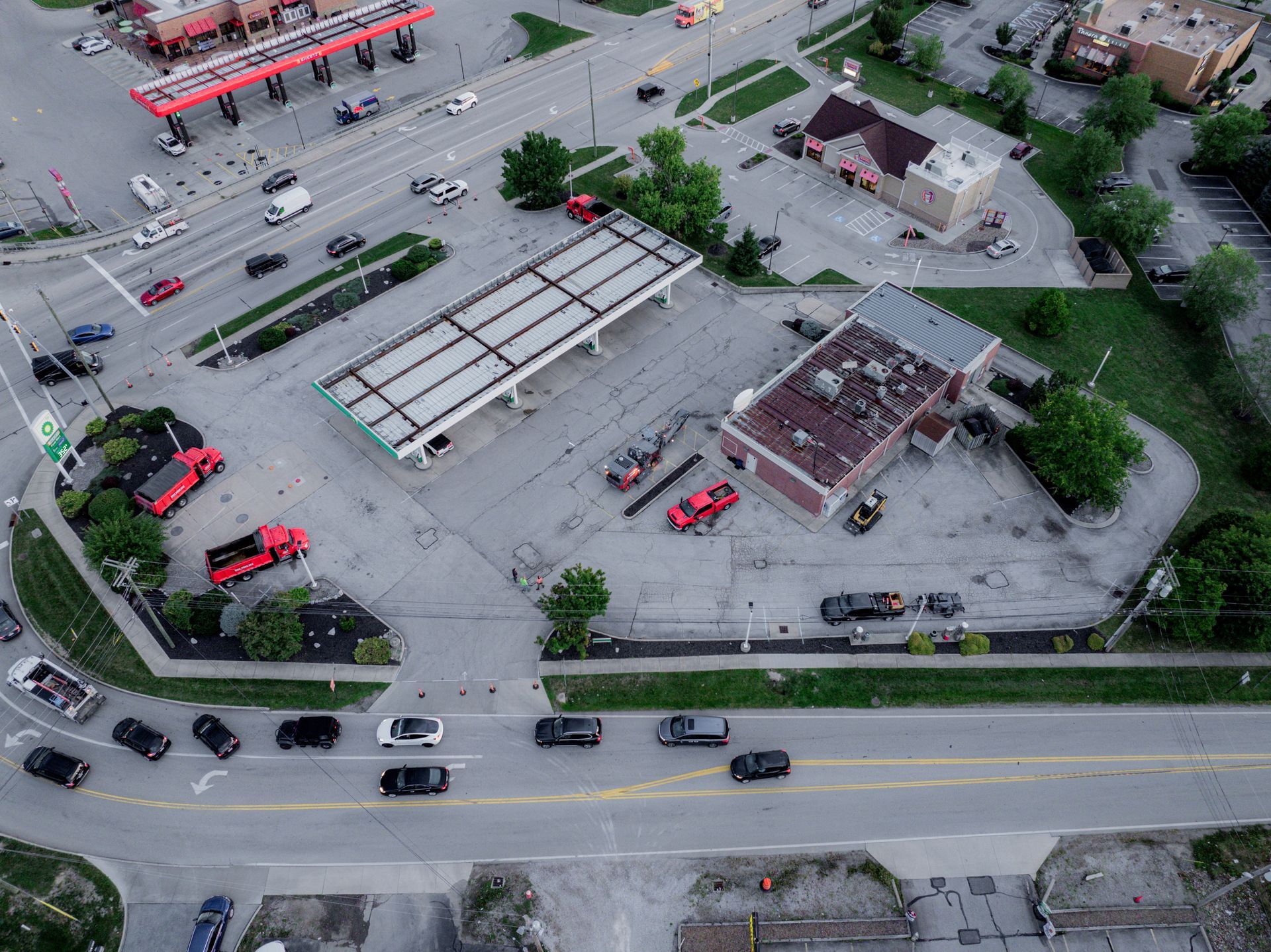 An aerial view of a gas station and parking lot before asphalt paving.