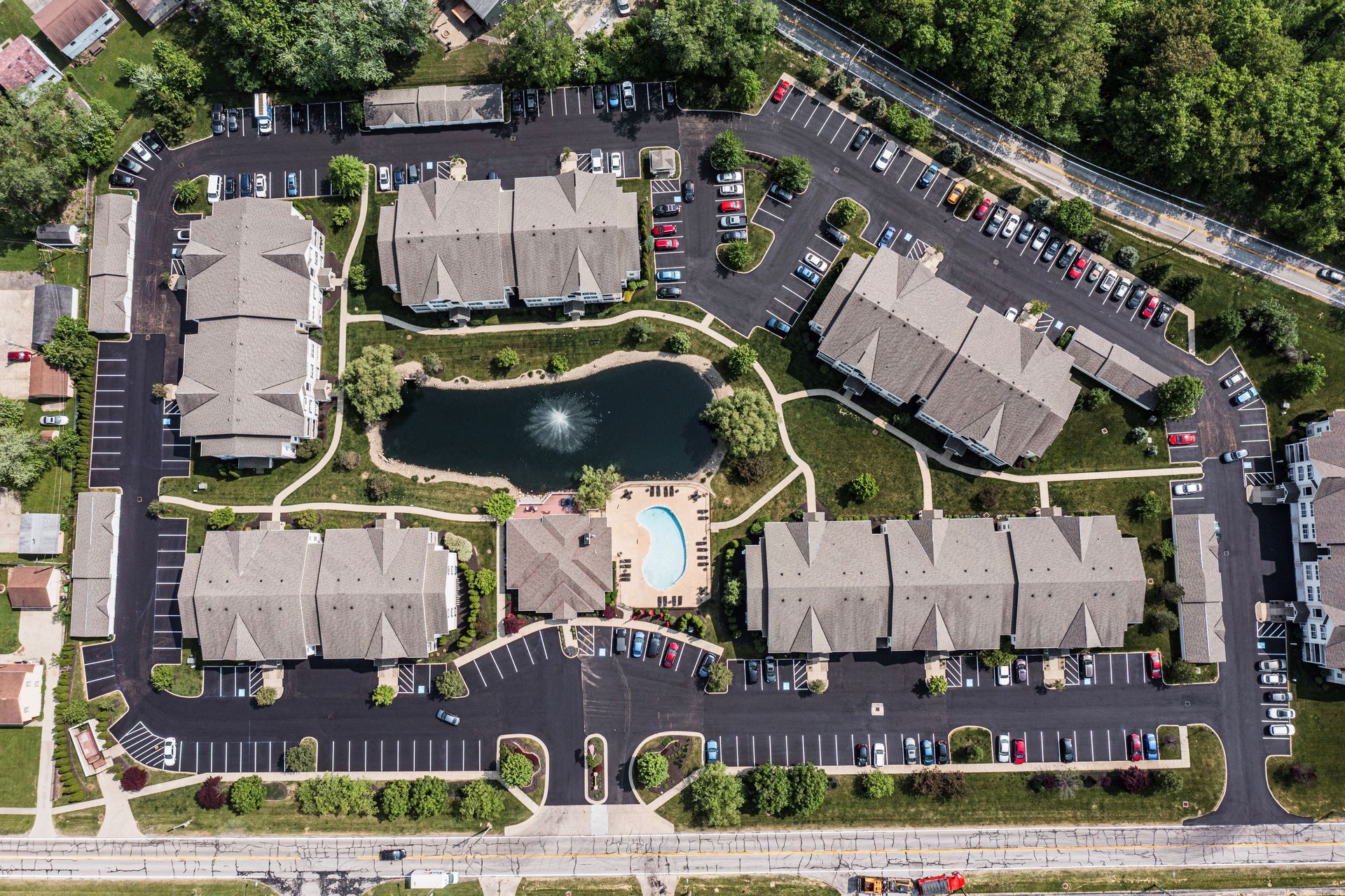 An aerial view of a residential area with lots of buildings and parking lots