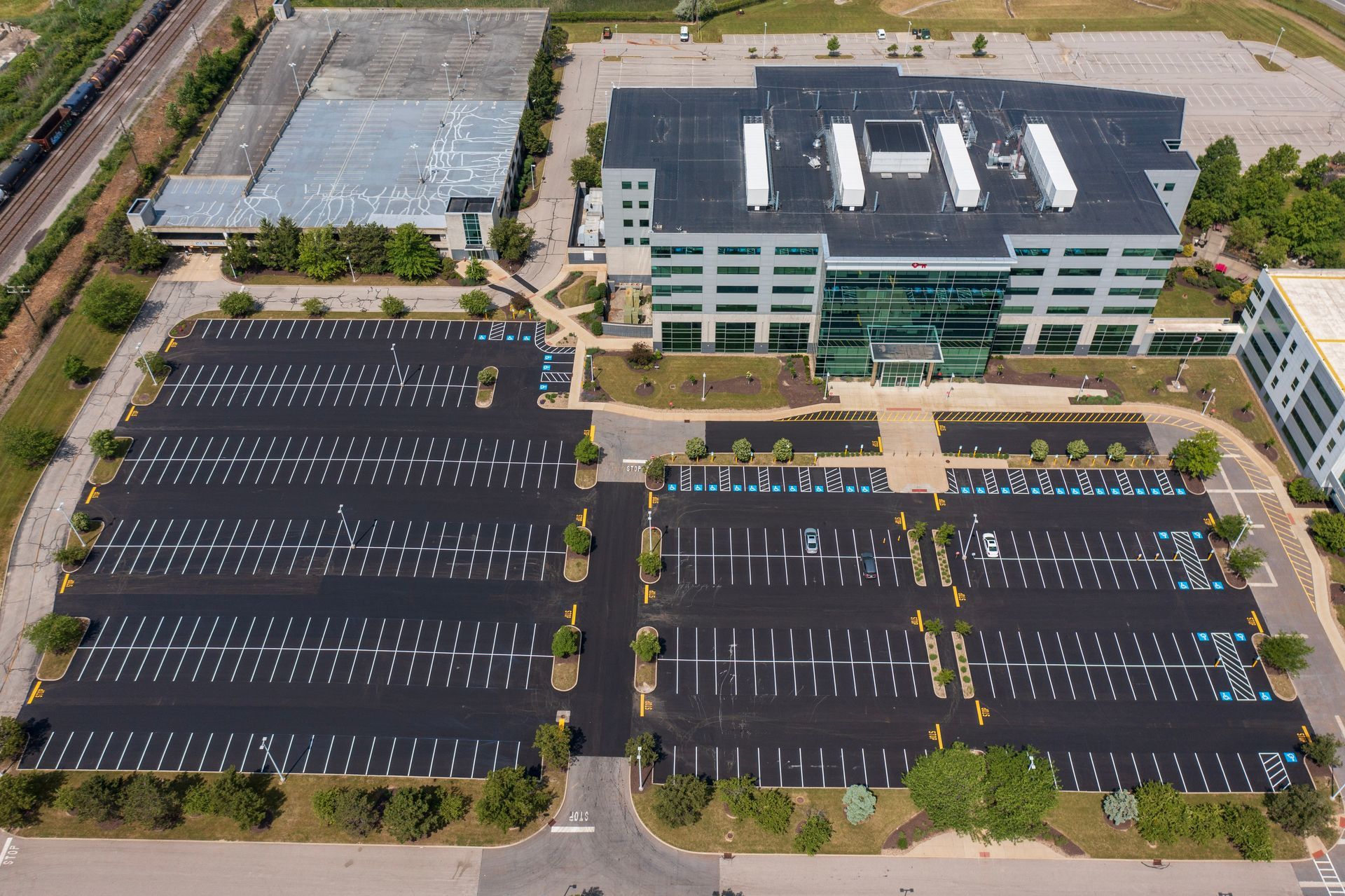 An aerial view of a large building with  parking spaces