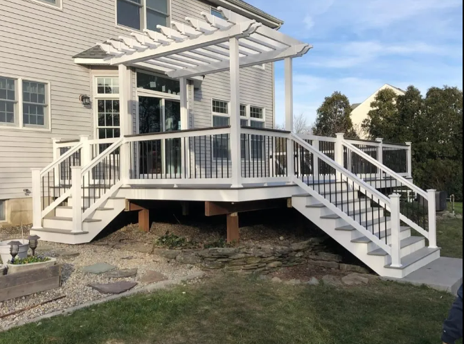 White screened porch with stairs and ramp on the side of a house