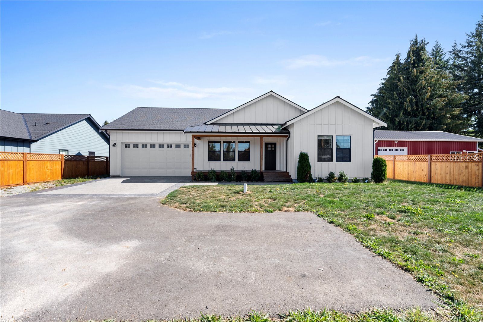 A white house with a fence in front of it