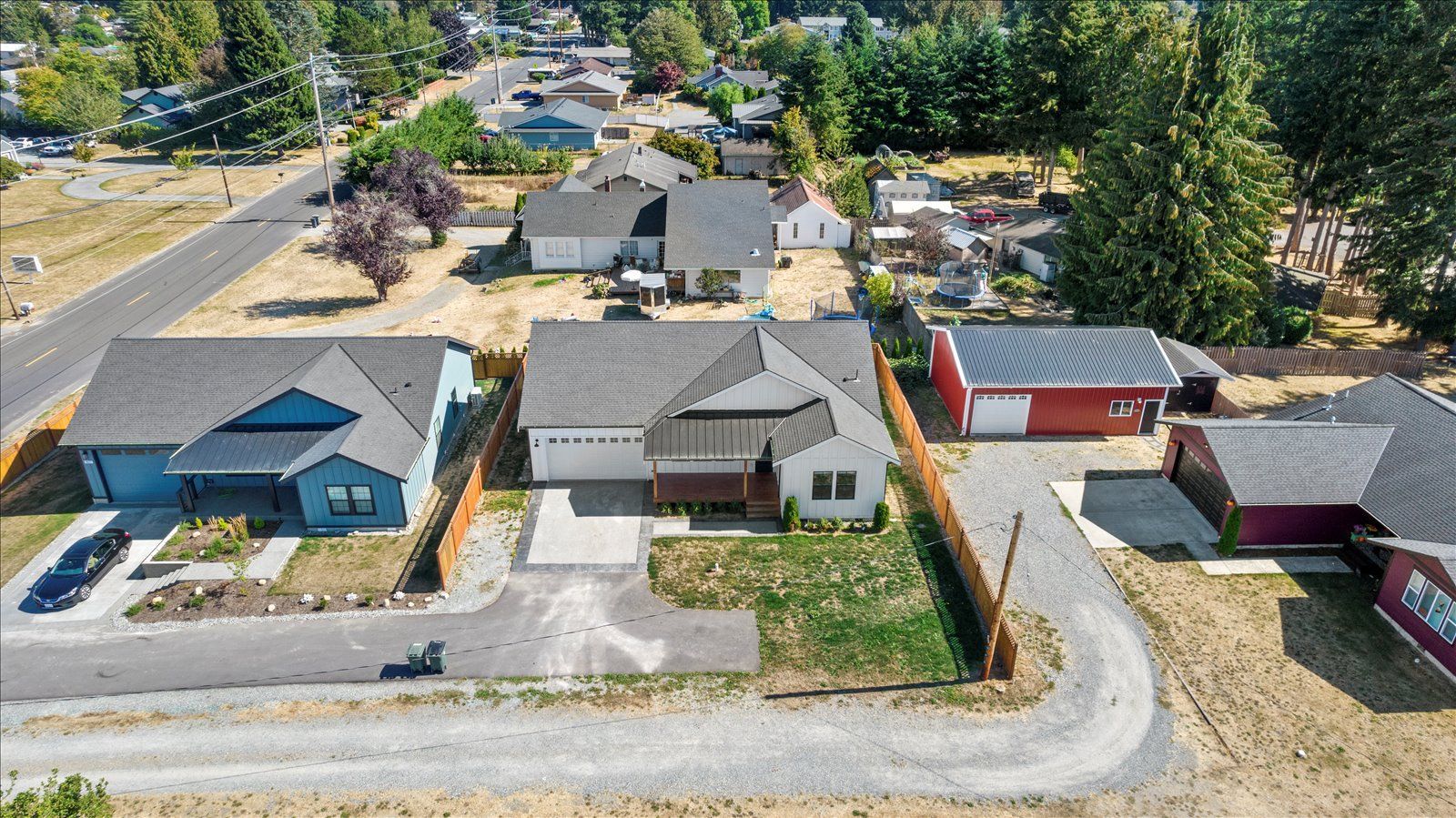 An aerial view of a residential neighborhood with houses and garages.