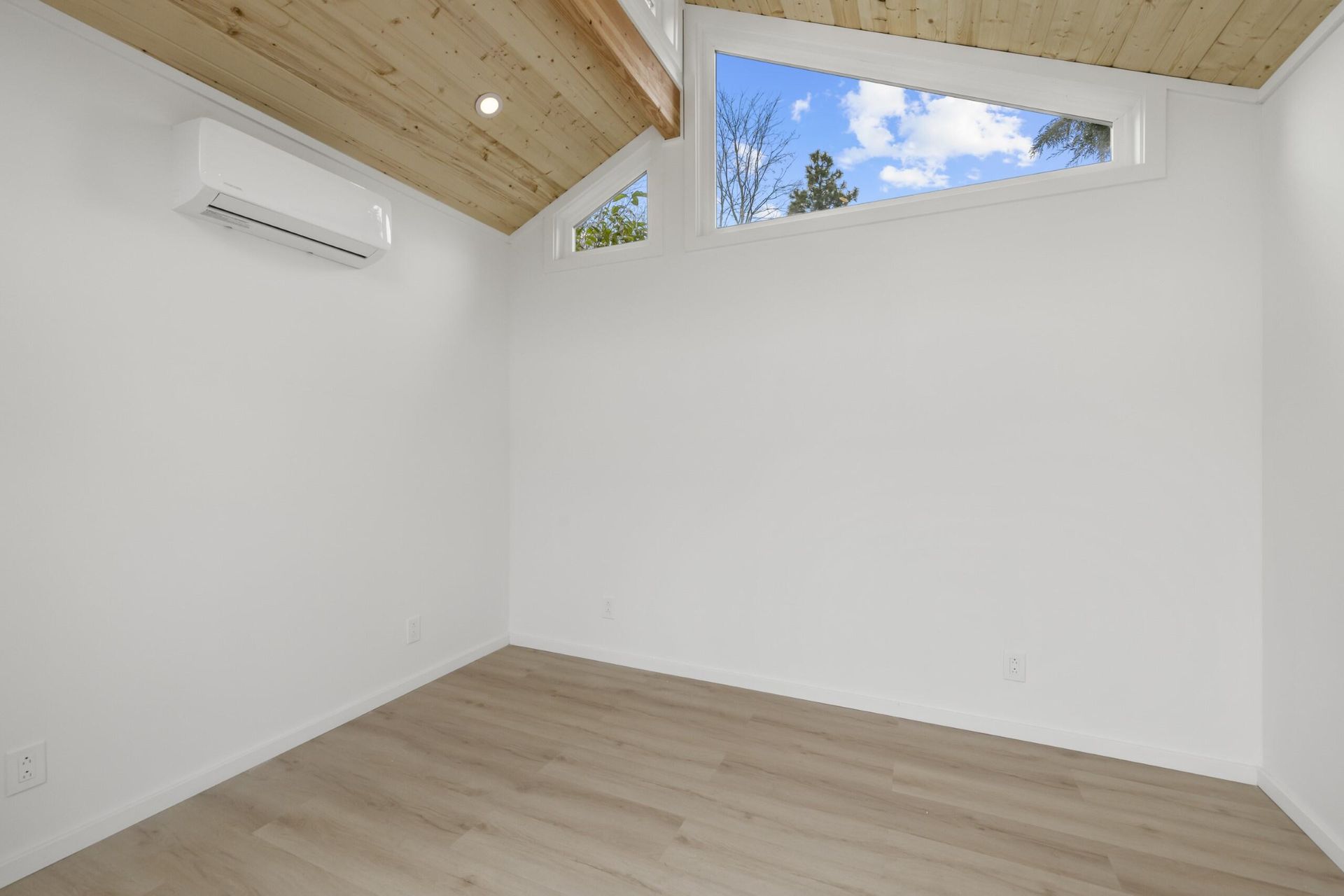 There is a window in the corner of the room.