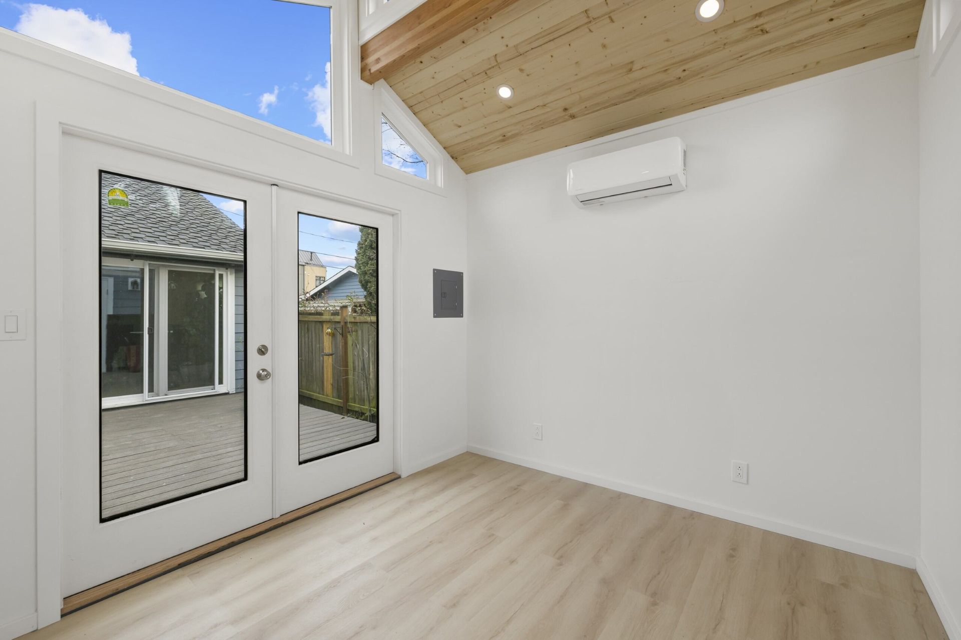 An empty room with a sliding glass door and a window.