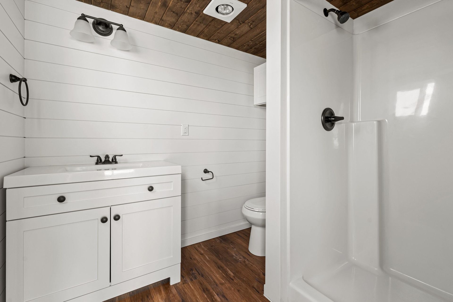 A bathroom with a sink, toilet and shower.