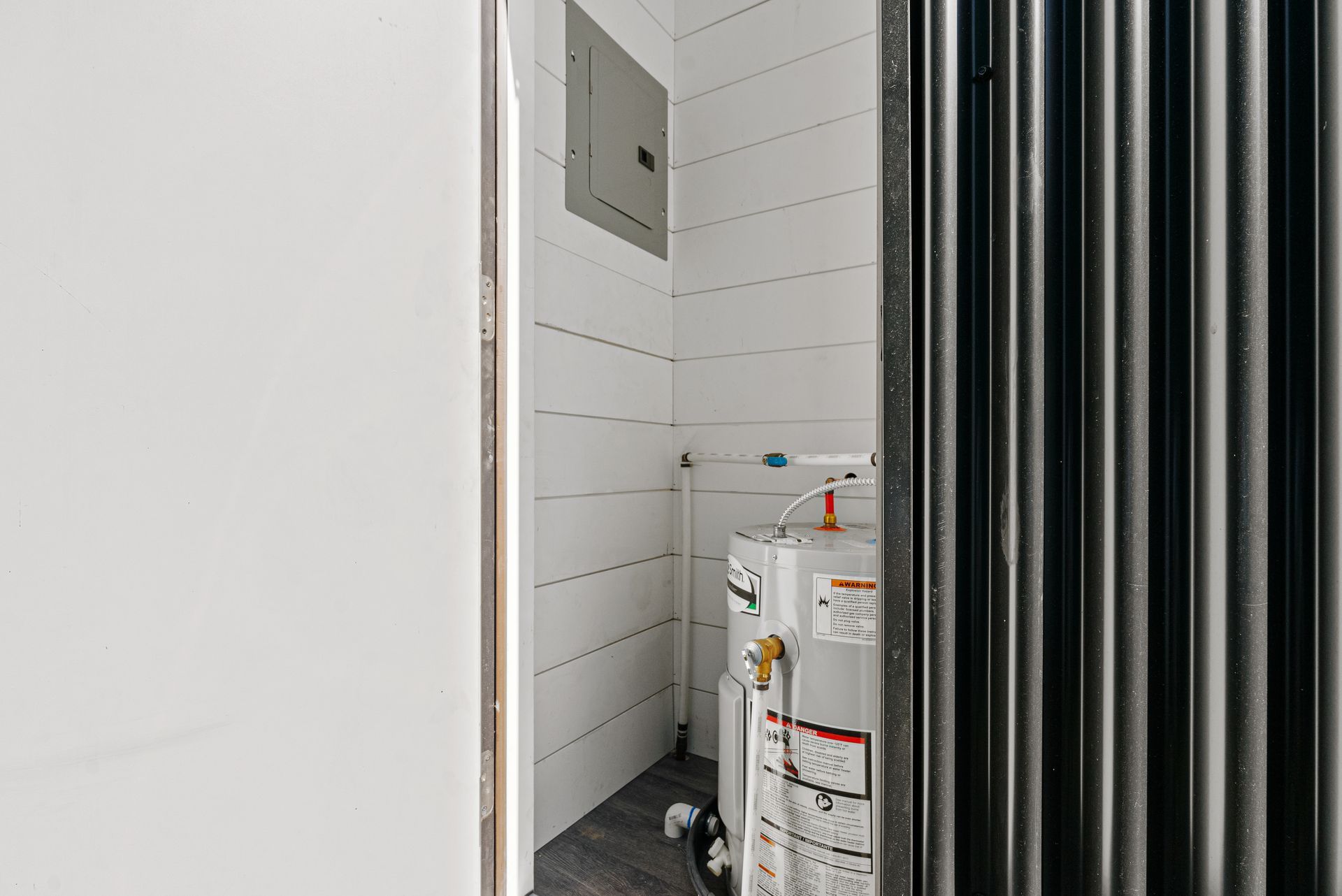 There is a water heater in the corner of the room.