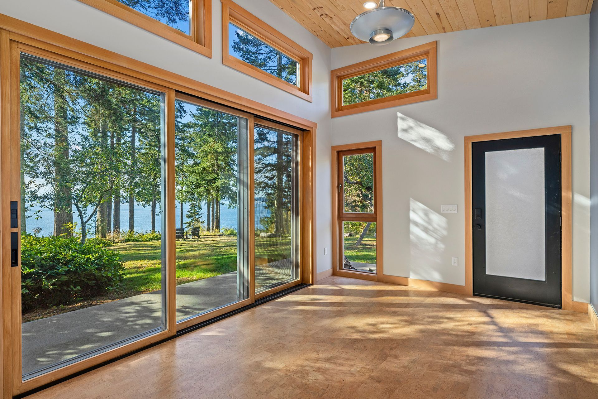 An empty room with lots of windows and a door