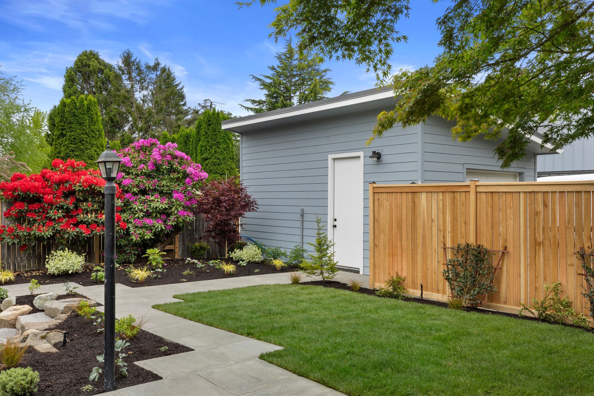 A house with a wooden fence and a walkway leading to it