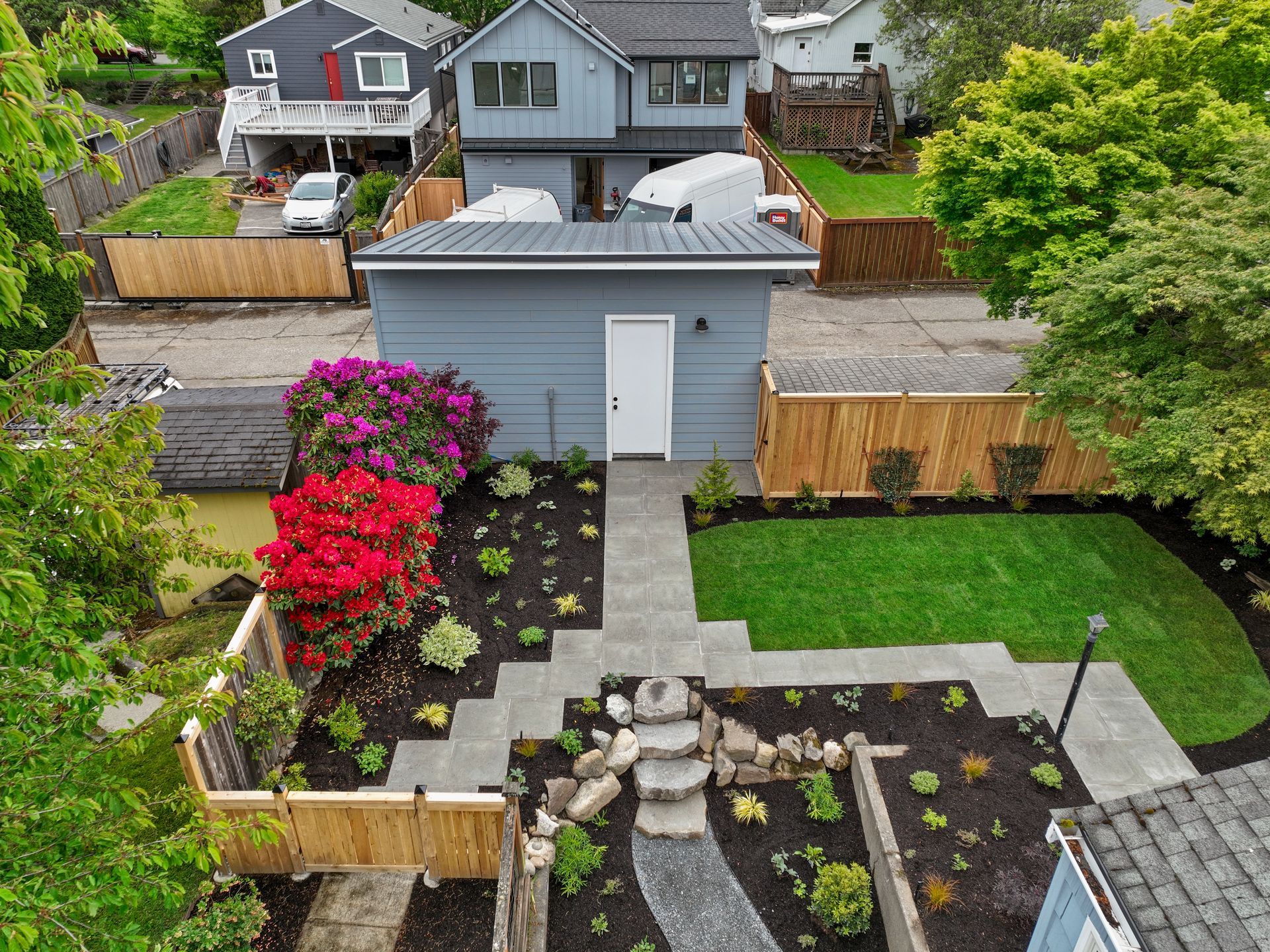 An aerial view of a house with a lush green yard.