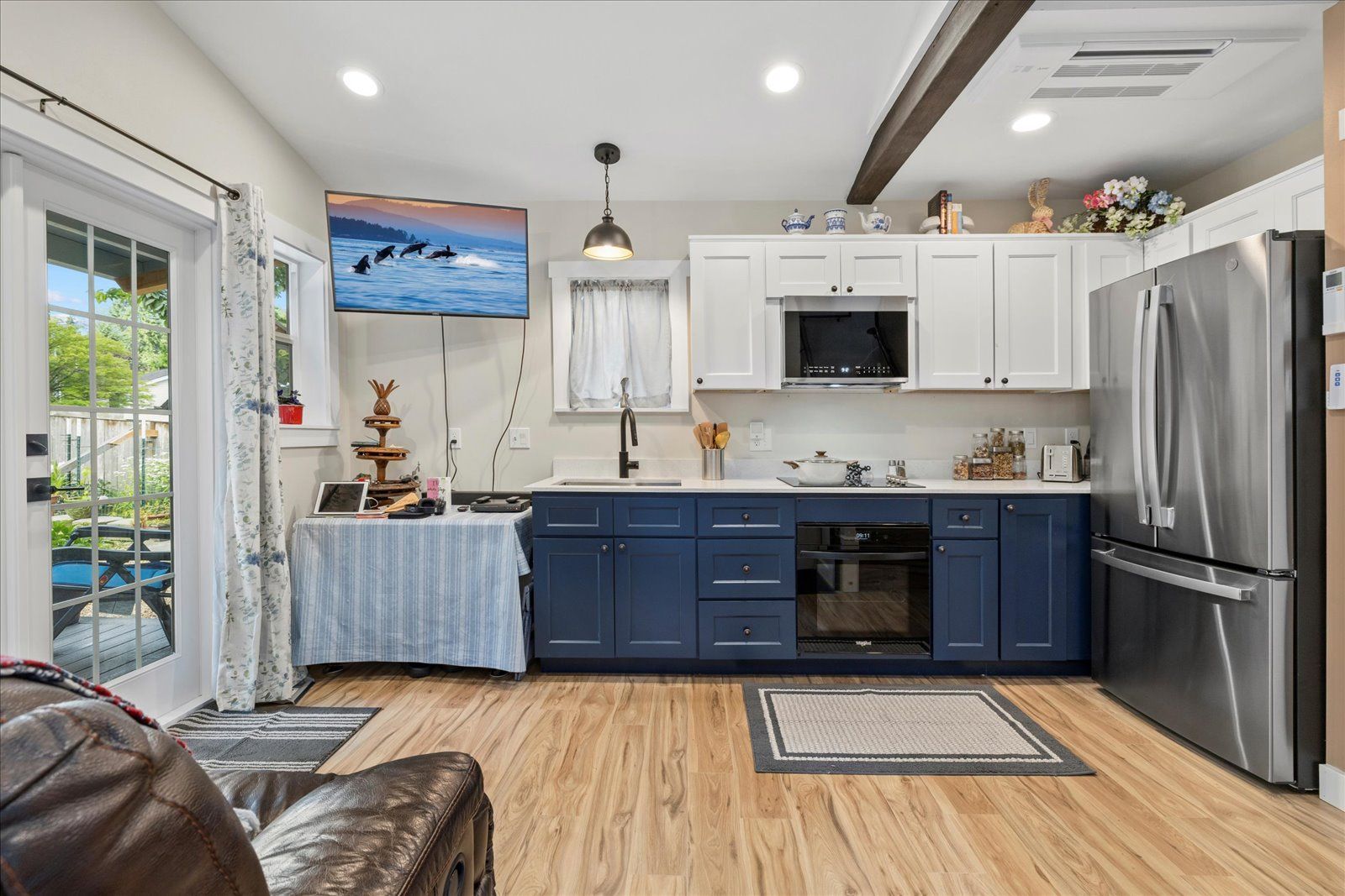 A kitchen with blue cabinets and stainless steel appliances