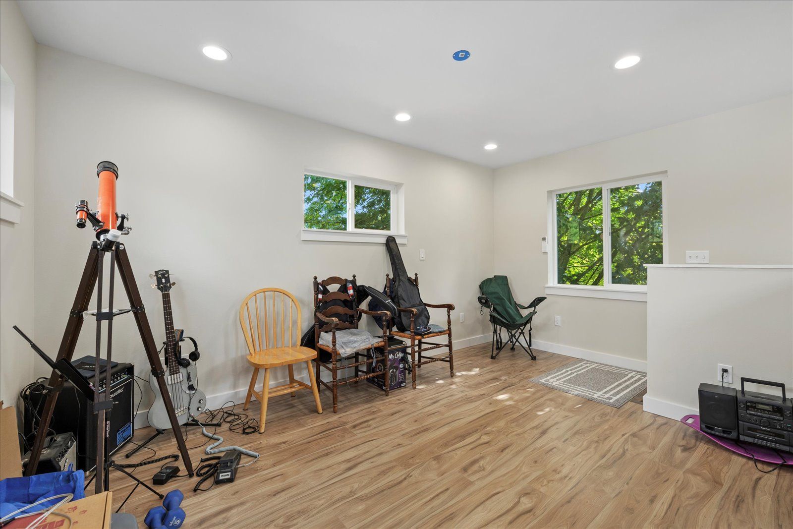 A room with wooden floors and a telescope in it.
