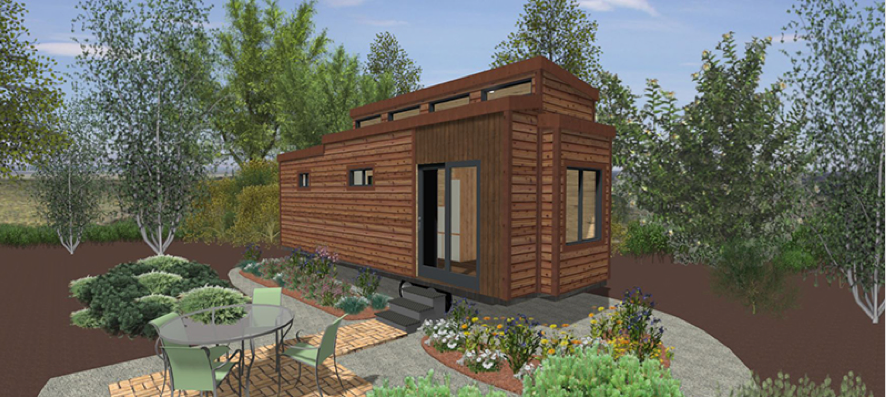 An artist's impression of a tiny house with a table and chairs in front of it.